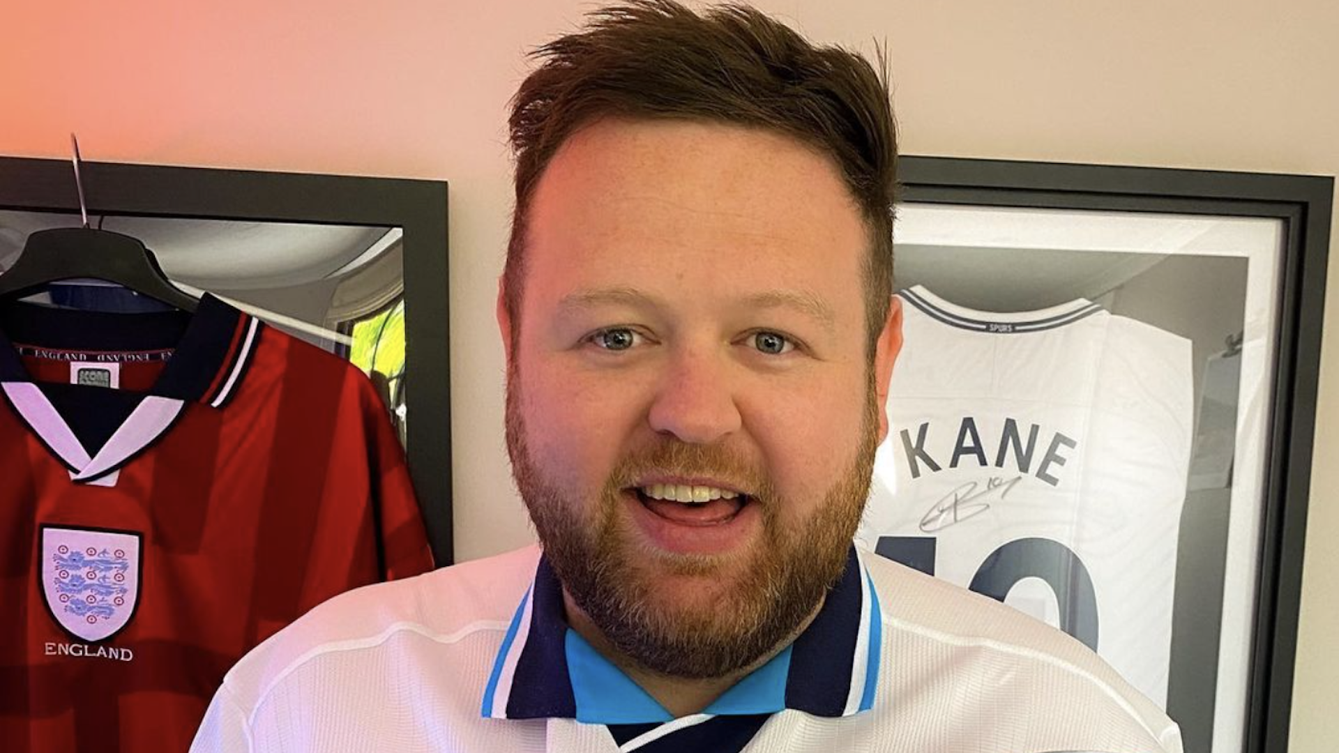 La5ty in front of framed England shirts
