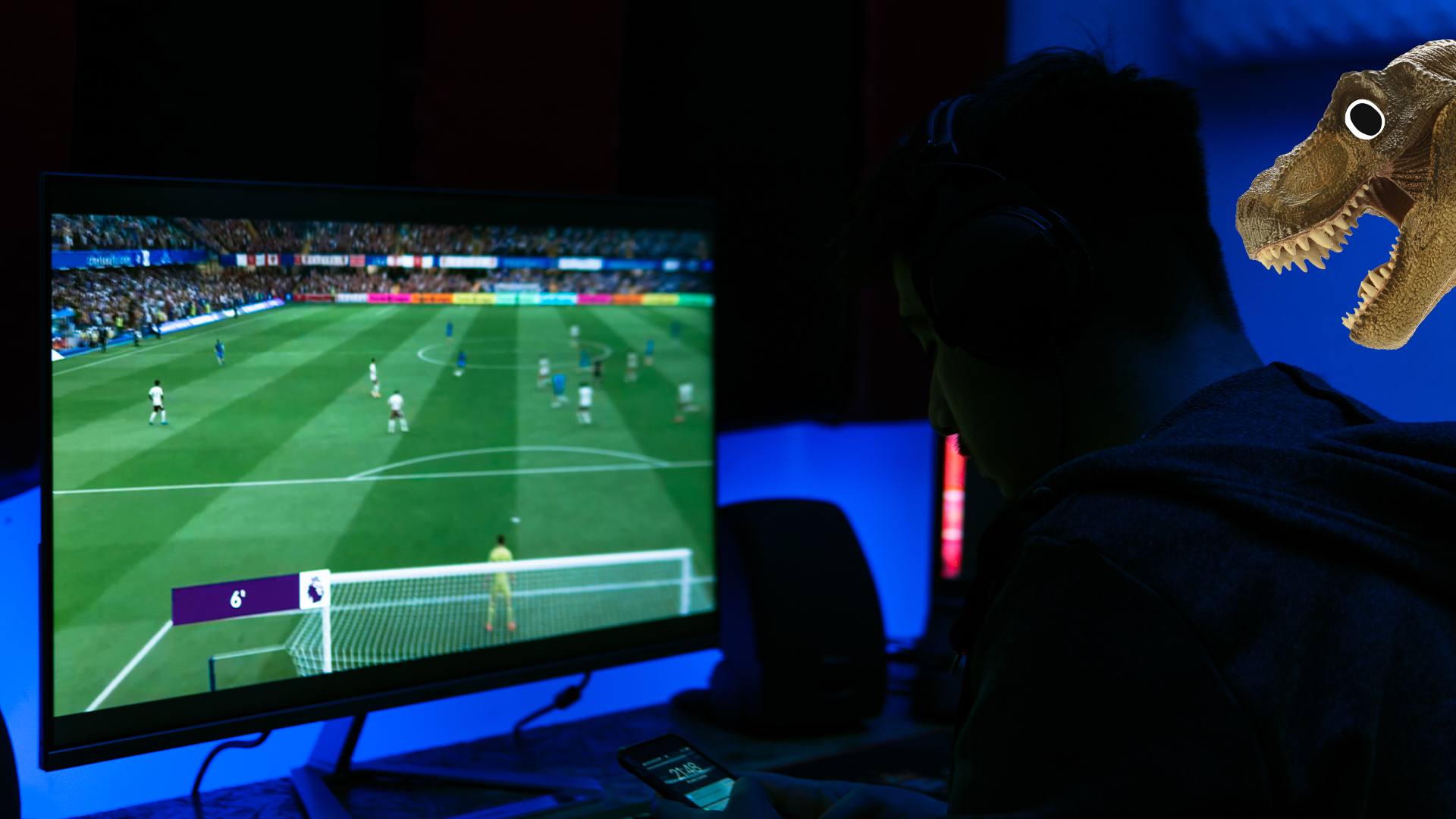 Dinosaur looking at man playing FIFA