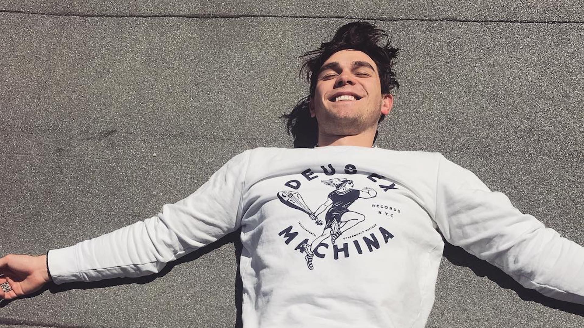 KJ Apa relaxing on the floor